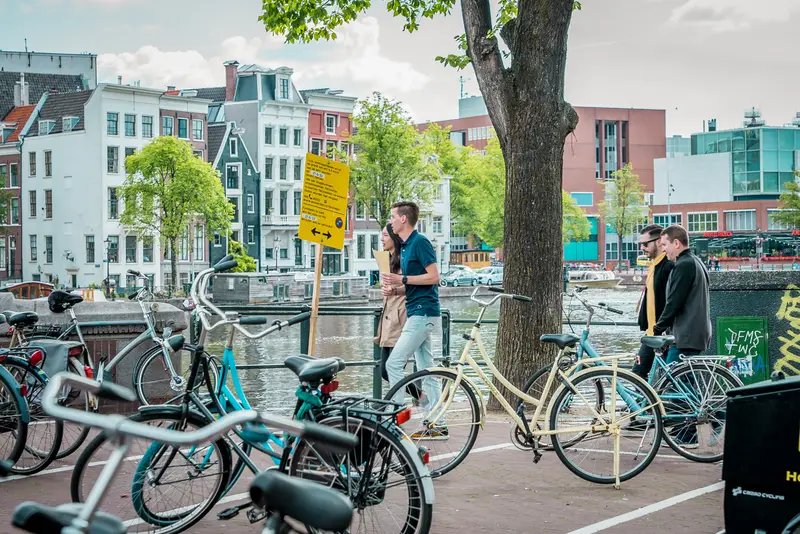 Team navigating Amsterdam streets with bicycles during the Treasure Hunt