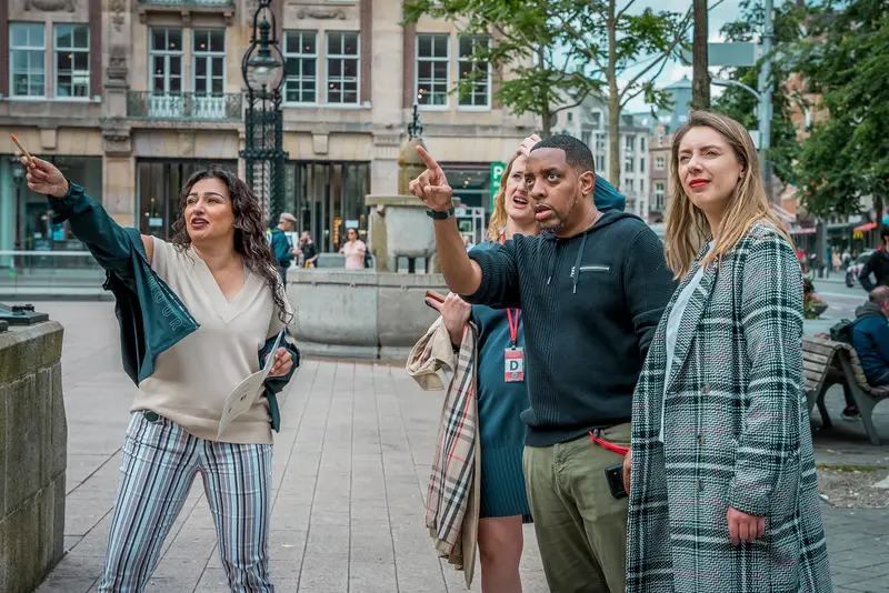 Teams exploring Amsterdam's canal ring during a corporate treasure hunt